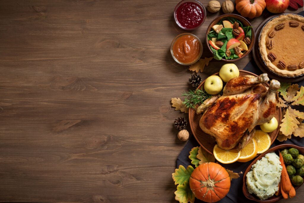 Thanksgiving foods arranged on a dark brown table